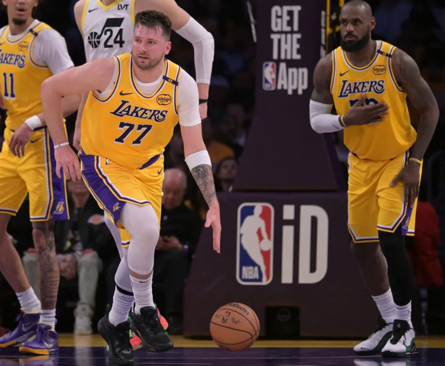 Feb 10, 2025; Los Angeles, California, USA; Los Angeles Lakers guard Luka Doncic (77) takes the ball down court as forward LeBron James (23) looks on against the Utah Jazz at Crypto.com Arena. Mandatory Credit: Jayne Kamin-Oncea-Imagn Images