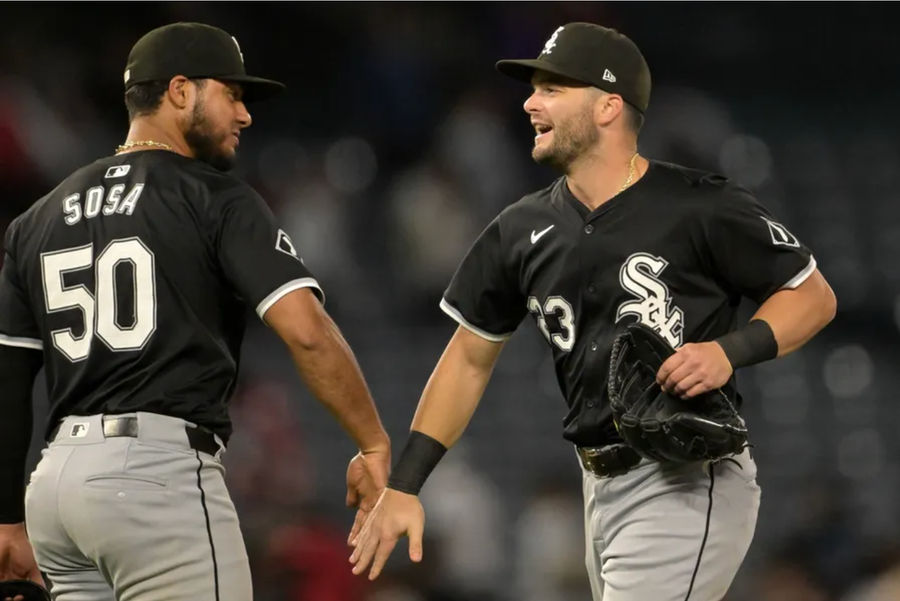 Sep 16, 2024; Anaheim, California, USA; Chicago White Sox left fielder Andrew Benintendi (23) and second baseman Lenyn Sosa (50) head off the field after the final out of the ninth inning defeating the Los Angeles Angels at Angel Stadium. Mandatory Credit: Jayne Kamin-Oncea-Imagn Images