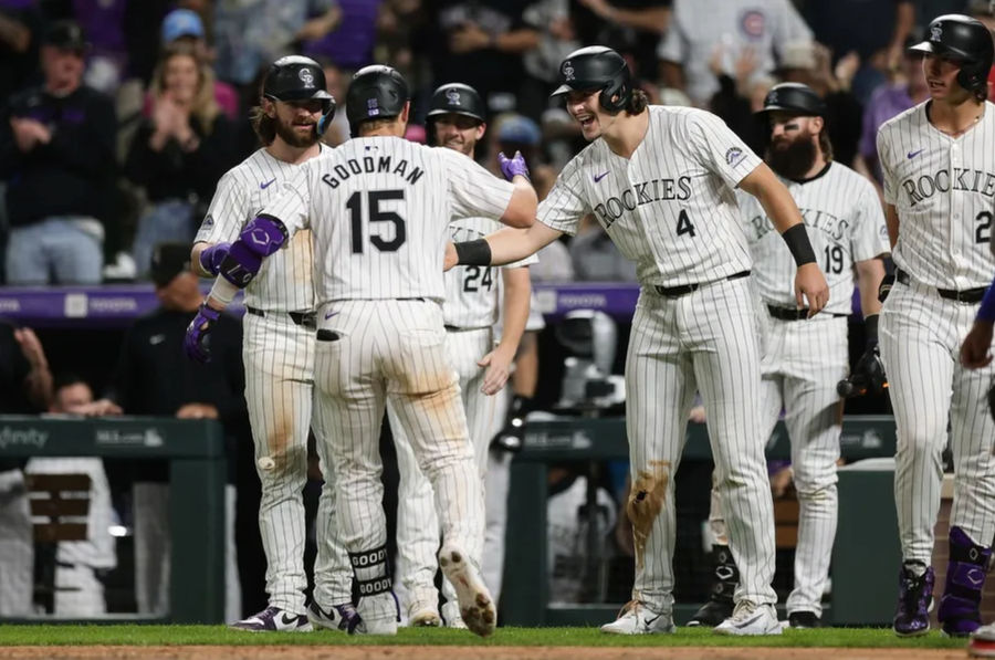 Sep 13, 2024; Denver, Colorado, USA; Colorado Rockies catcher Hunter Goodman (15) celebrates with first baseman Michael Toglia (4) and second baseman Brendan Rodgers (7) after hitting a grand slam in the eighth inning against the Chicago Cubs at Coors Field. Mandatory Credit: Isaiah J. Downing-Imagn Images