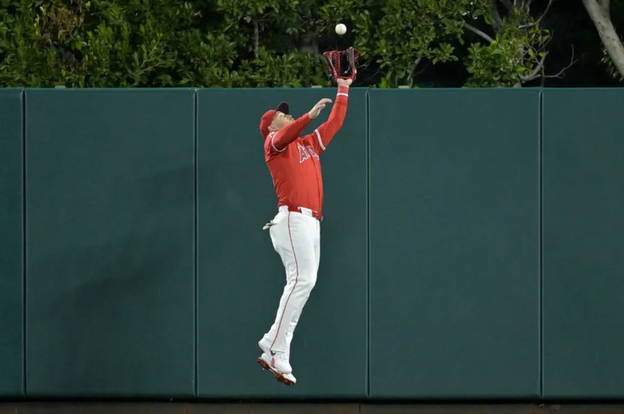 Apr 6, 2024; Anaheim, California, USA; Los Angeles Angels outfielder Mike Trout (27) makes a leaping catch at the wall off a fly ball hit by Boston Red Sox outfielder Jarren Duran (16) in the eighth inning at Angel Stadium. Mandatory Credit: Jayne Kamin-Oncea-Imagn Images