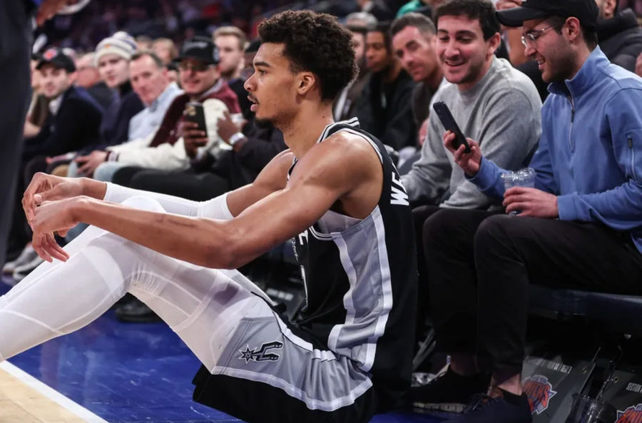 Dec 25, 2024; New York, New York, USA; San Antonio Spurs center Victor Wembanyama (1) sits on the floor after getting fouled in the third quarter against the New York Knicks at Madison Square Garden. Mandatory Credit: Wendell Cruz-Imagn Images