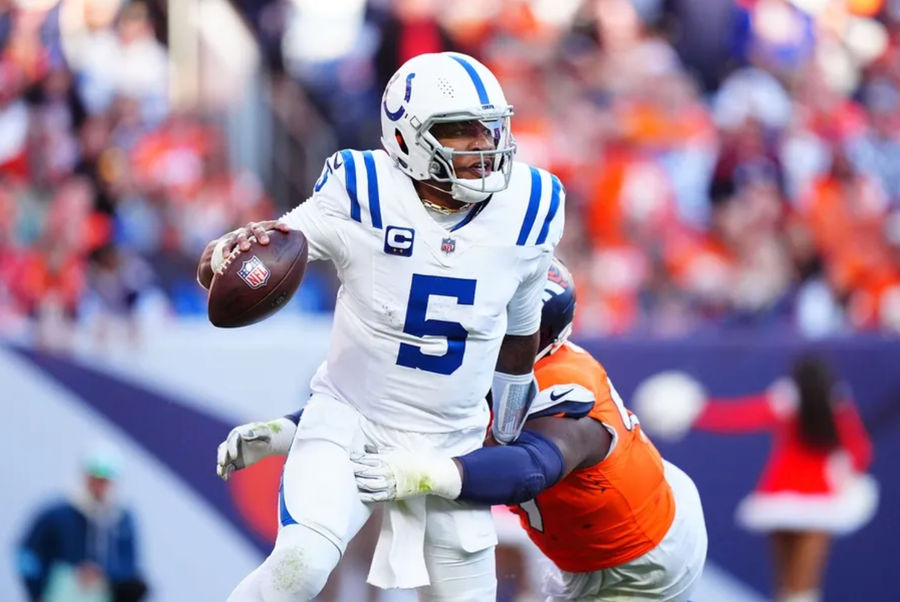 Dec 15, 2024; Denver, Colorado, USA; Indianapolis Colts quarterback Anthony Richardson (5) runs past the tackle of Denver Broncos defensive tackle Malcolm Roach (97) in the second quarter at Empower Field at Mile High. Mandatory Credit: Ron Chenoy-Imagn Images