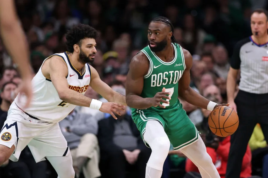 Mar 2, 2025; Boston, Massachusetts, USA; Boston Celtics forward Jaylen Brown (7) dribbles down the court defended by Denver Nuggets guard Jamal Murray (27) during the first half at TD Garden. Mandatory Credit: Paul Rutherford-Imagn Images