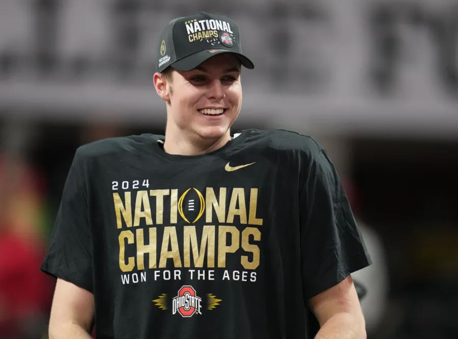 Jan 20, 2025; Atlanta, GA, USA; Ohio State Buckeyes quarterback Will Howard (18) on the podium after defeating the Notre Dame Fighting Irish in the CFP National Championship college football game at Mercedes-Benz Stadium. Mandatory Credit: Kirby Lee-Imagn Images