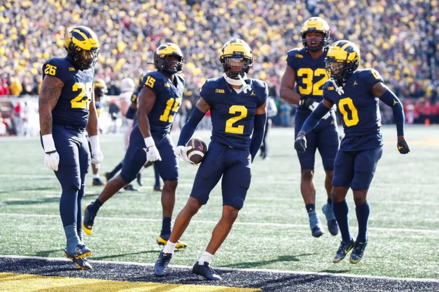 Michigan defensive back Will Johnson celebrates after intercepting a pass from Ohio State quarterback Kyle McCord during the first half at Michigan Stadium in Ann Arbor on Saturday, Nov. 25, 2023. PHOTO USA TODAY SPORTS IMAGES.