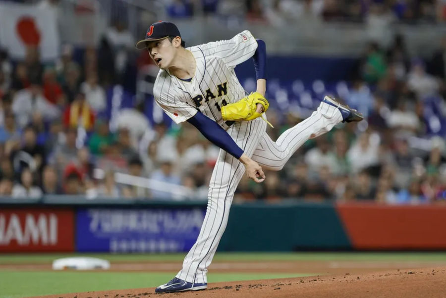 Mar 20, 2023; Miami, Florida, USA; Japan starting pitcher Roki Sasaki (14) delivers a pitch during the first inning against Mexico at LoanDepot Park. Mandatory Credit: Sam Navarro-Imagn Images