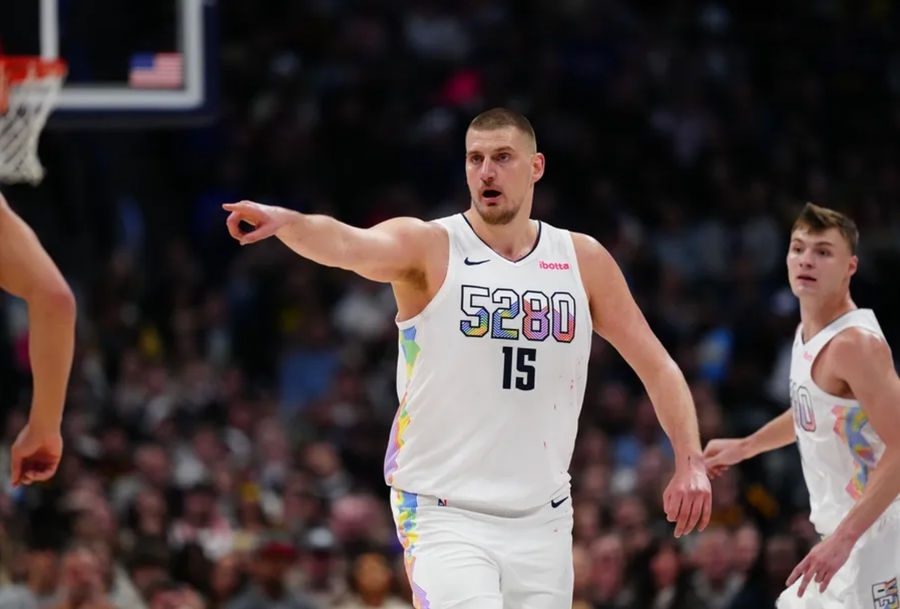 Mar 7, 2025; Denver, Colorado, USA; Denver Nuggets center Nikola Jokic (15) points in the second half against the Phoenix Suns at Ball Arena. Mandatory Credit: Ron Chenoy-Imagn Images