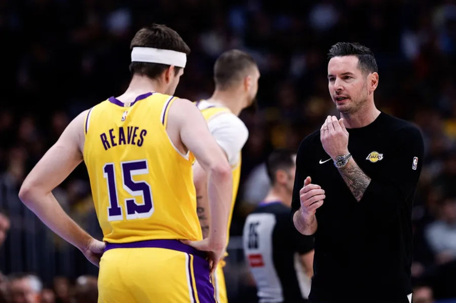 Mar 14, 2025; Denver, Colorado, USA; Los Angeles Lakers head coach JJ Redick talks with guard Austin Reaves (15) in the first quarter against the Denver Nuggets at Ball Arena. Mandatory Credit: Isaiah J. Downing-Imagn Images