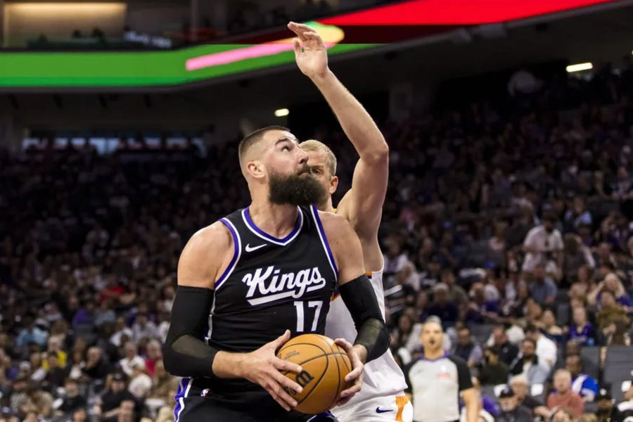 April 13, 2025; Sacramento, California, USA; The Sacramento Kings Center Jonas Valansiyunas (17) defends during the second quarter at Golden 1 center to shoot as Phoenix Sun Center Mason Plumli (22). Compulsory Credit: John Hefty-Emagan Picture