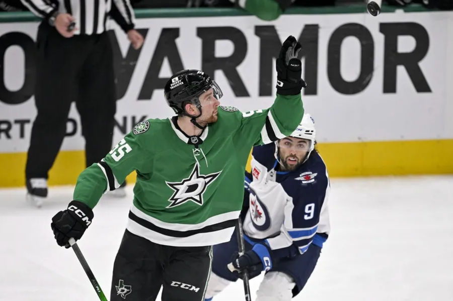 May 17, 2025; Dallas, Texas, USA; Dallas Stars defender Thomas Harley (55), Winnipeg Jets Left Wing Alex Iaallo (9), American Airlines Center in the second period of the second round of the second round of the 2025 Stanley Cup playoffs captures the disk in the air. Compulsory Credit: Jerome Miron-Imagni Images