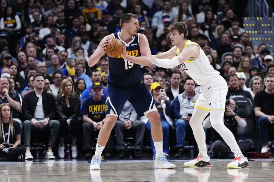 March 28, 2025; Denver, Colorado, USA; Utah Jazz Advanced Kyle Filipowski (22) defends on Nikola Jokic (15) in the second quarter of the Ball Arena. Compulsory Credit: Ron Chenoy-Imagni Images