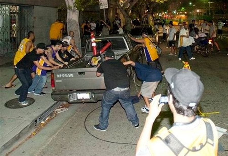 Los Angelenos Search For Championship Trophy Under Burning Cars