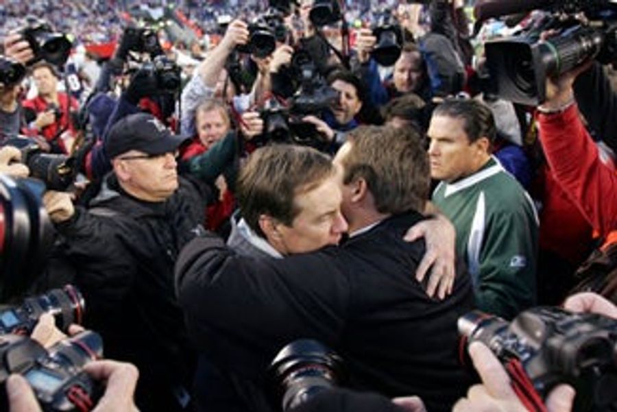 Many People Taking Photos Of Two Men Hugging