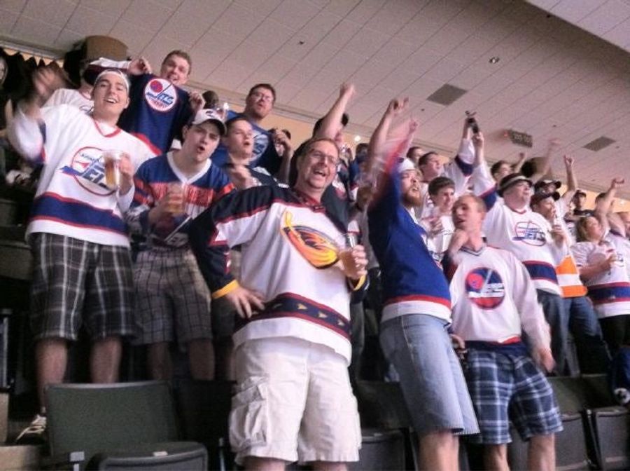 A Thrashers Fan Surrounded By Winnipeg Jets Fans At The Draft Tries To Mask His Pain With Smiles, Beers