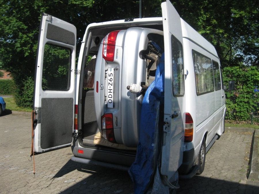 How The Hell Did This Car Get Inside This Van?