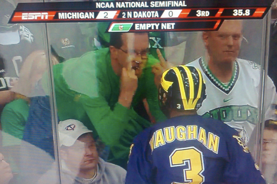 It Sure Looks Like This North Dakota Sioux Hockey Fan Has His Jeaned Ass Square In His Wife's Face