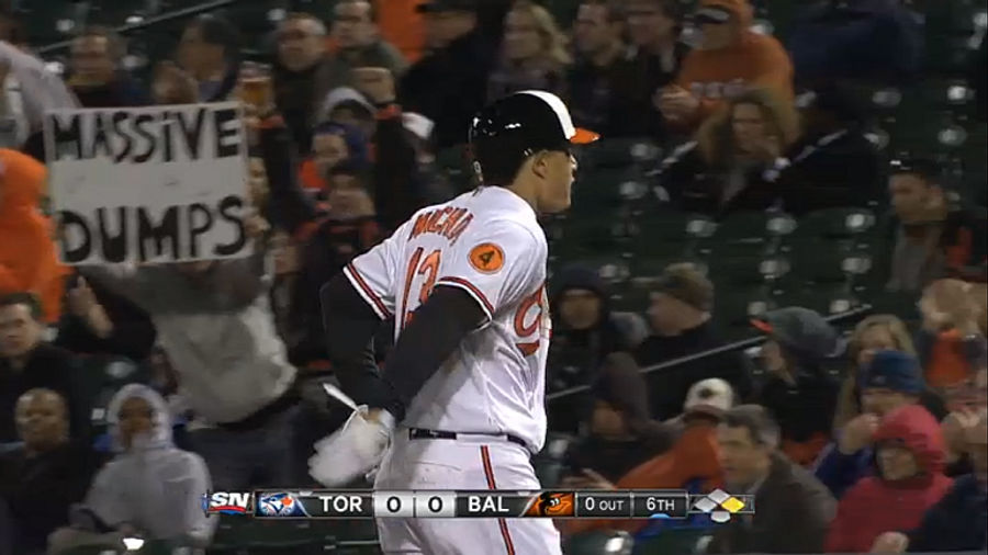 True Hero Holds Up "Massive Dumps" Sign At Orioles Game