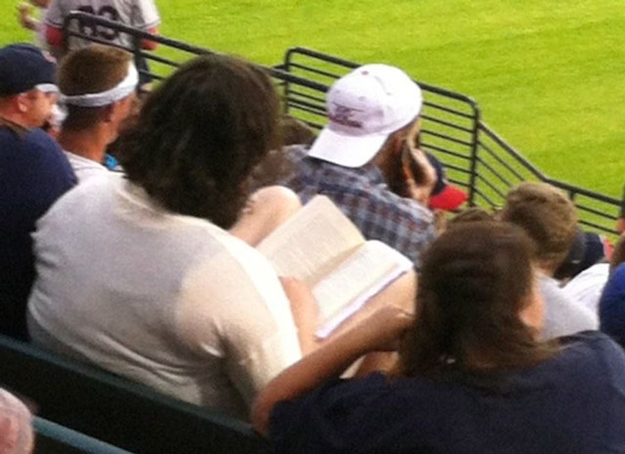 Yet Another Photo Of Someone Reading At A Baseball Game