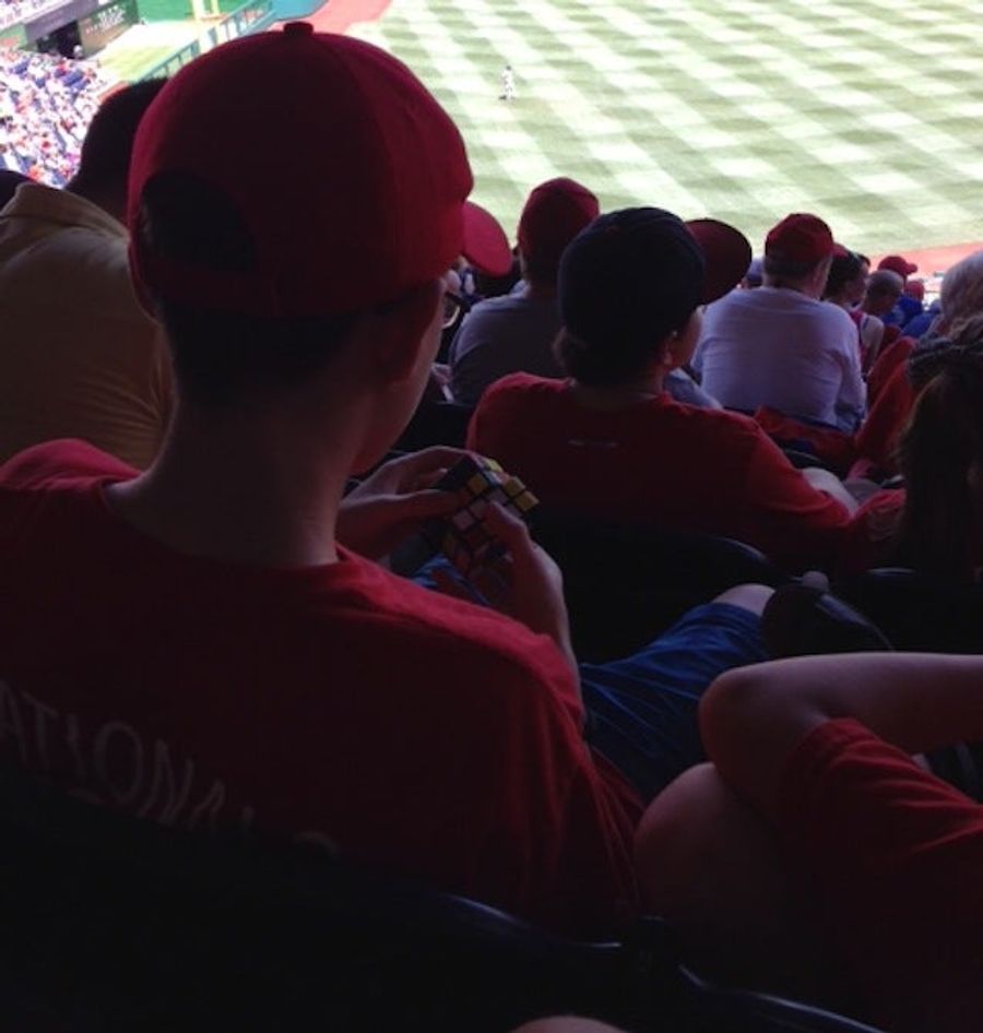 Here's A Bored Baseball Fan Playing With A Rubik's Cube