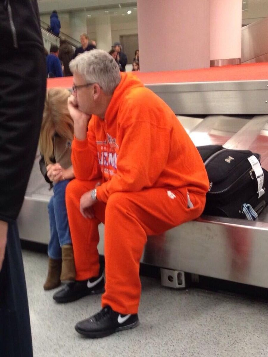 Rex Ryan Waits In Airport, Wears All-Orange Sweatsuit