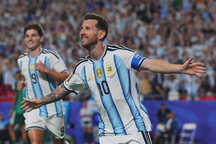 Lionel Messi's history-making hat trick carries Argentina past Algeria