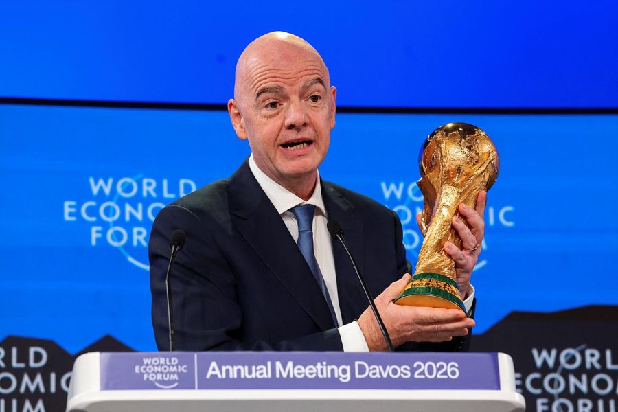 FIFA President Gianni Infantino holds the World Cup trophy.