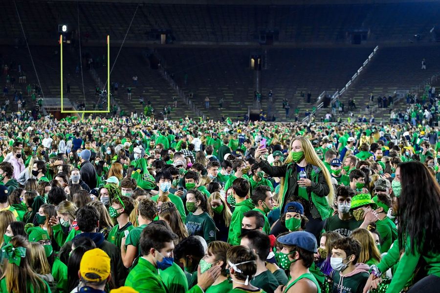 Dumb college kids at Notre Dame rush field in pandemic
