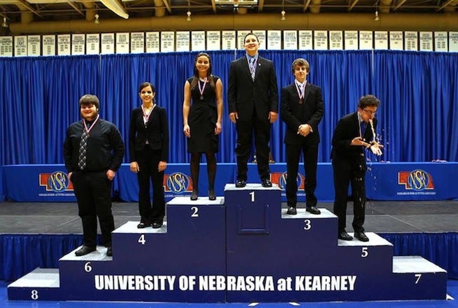 Speech Competition Punctuated With Kid Blowing Chunks On Medal Stand