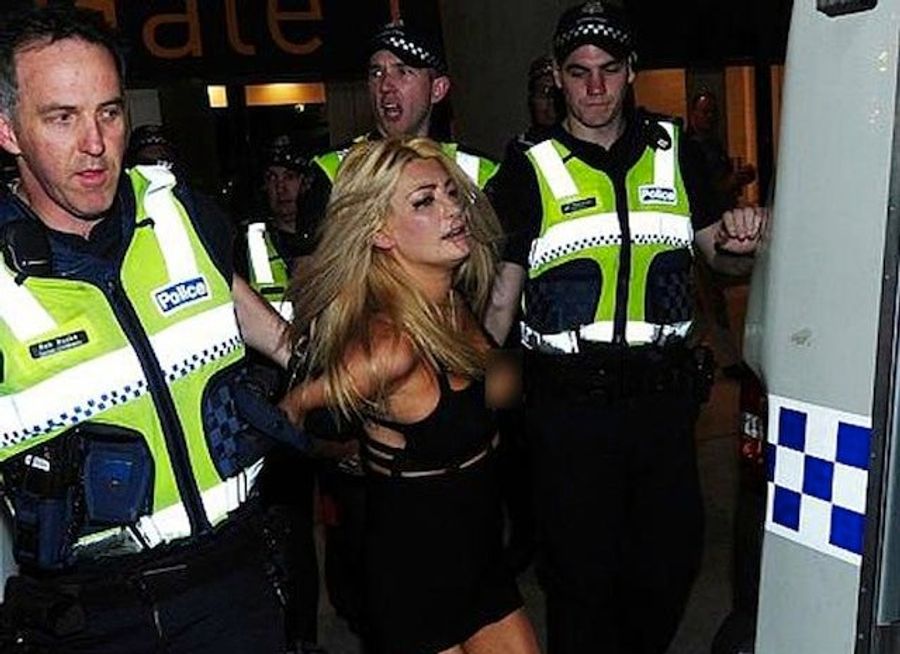 Model Strips Naked, Fights Cops At Aussie Rules Grand Final [NSFW]